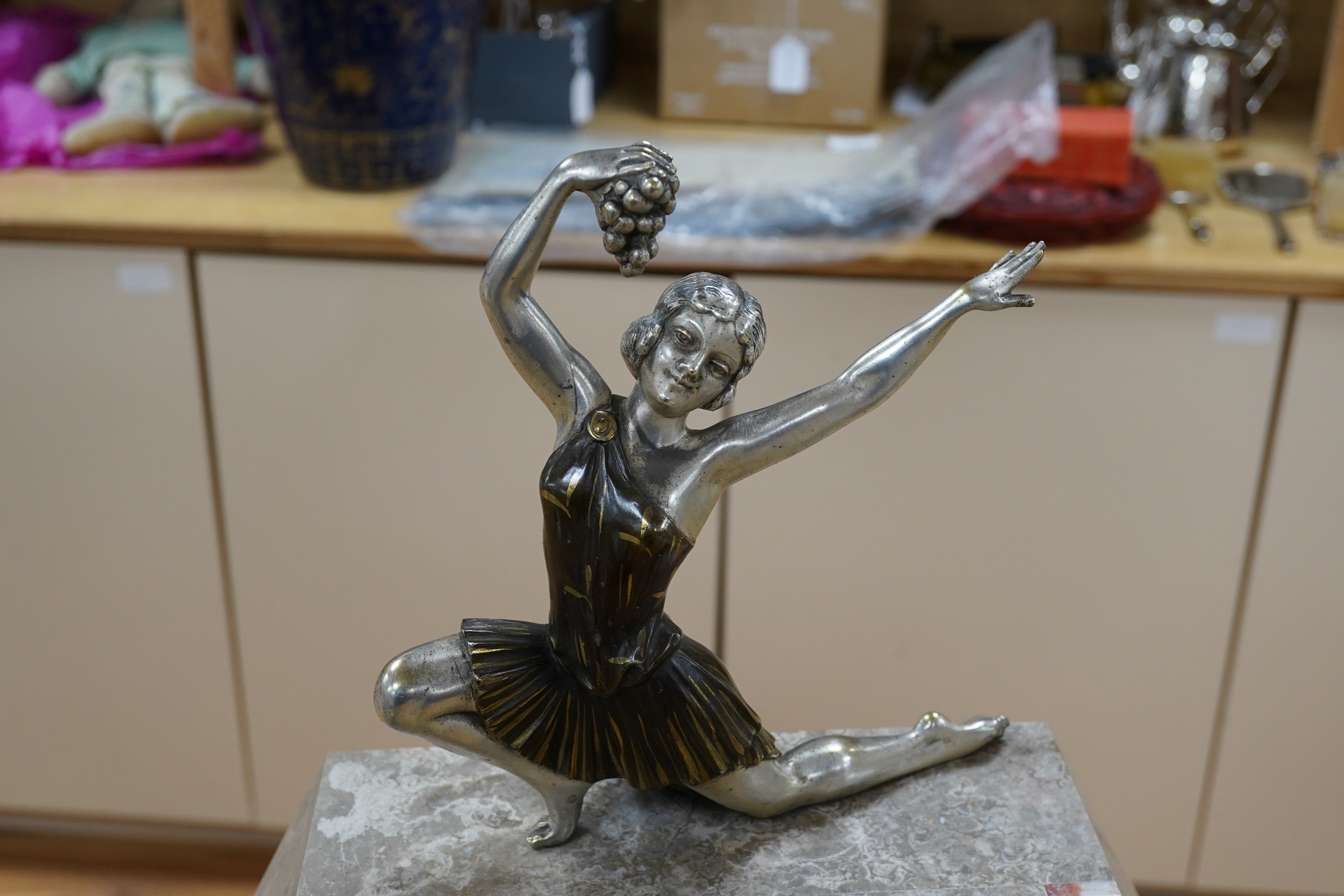 A French Art Deco clock garniture of mixed marble with chromed and painted spelter female dancer surmount. 40cm high. Condition - good